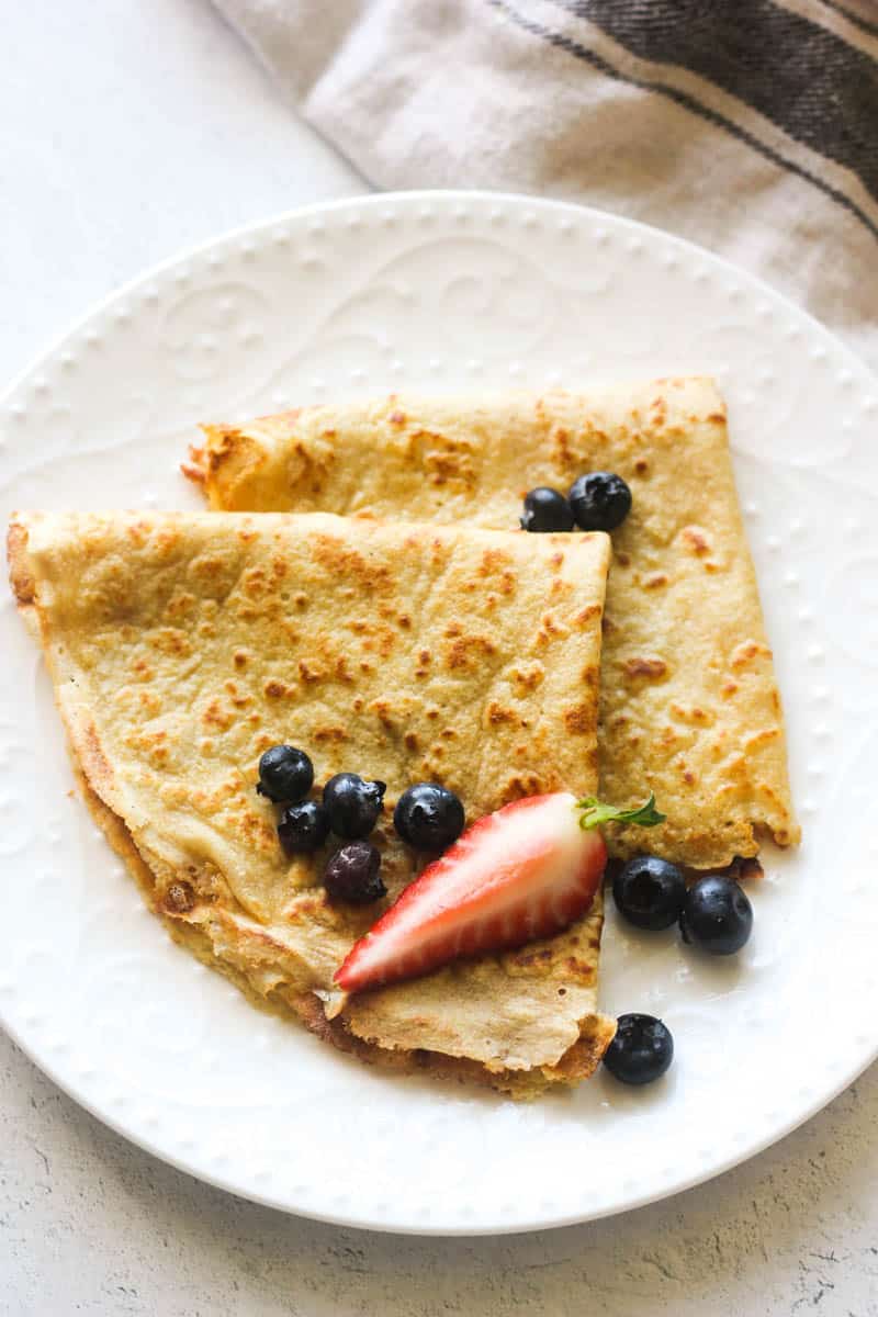 two kodiak crepes on a white plate with berries