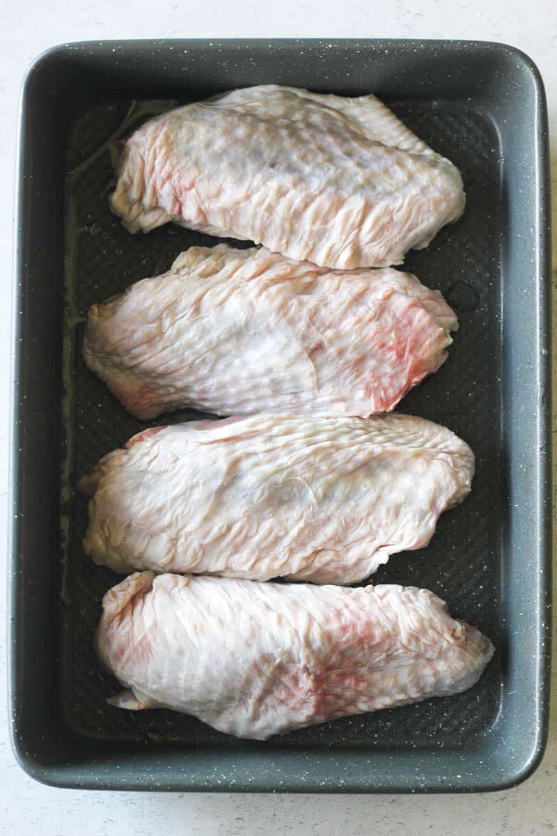 raw turkey wings in a baking dish