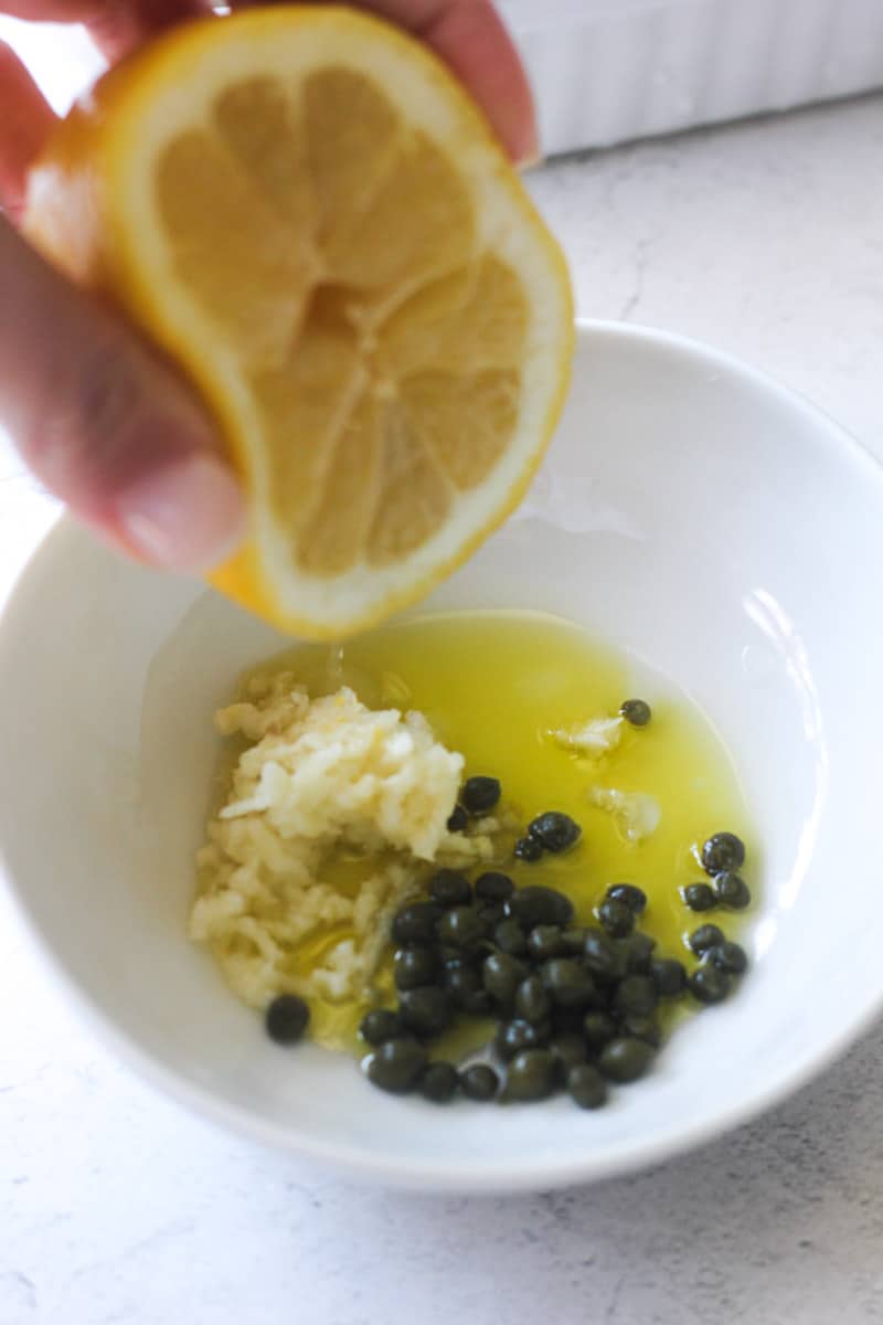 squeezing lemon into the small bowl