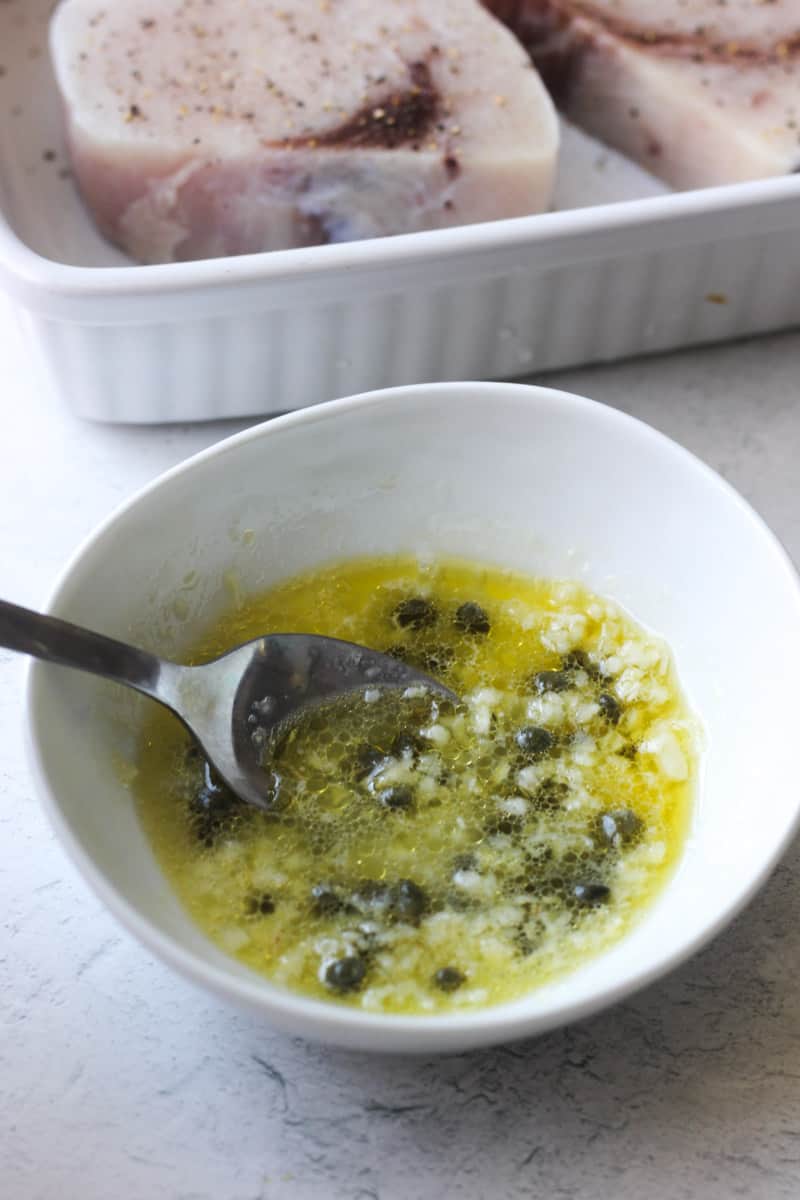 preparing oil butter capers mixture with garlic