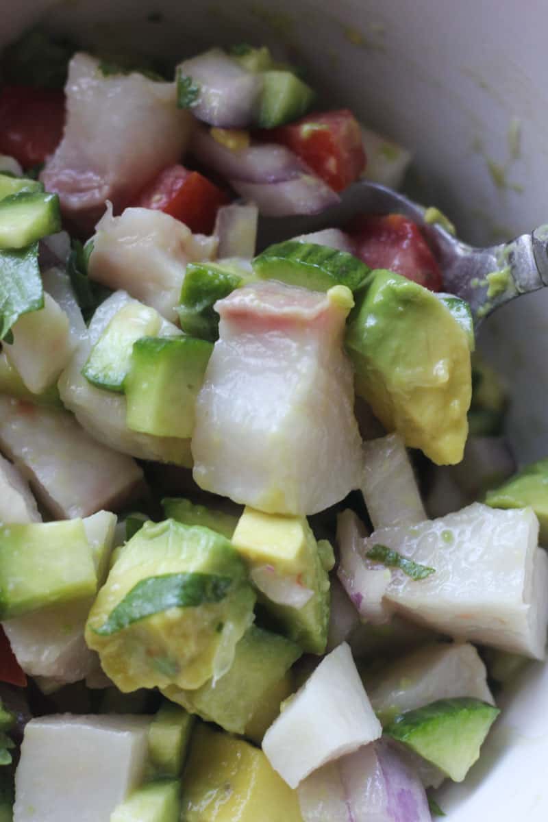 close picture of ceviche with cobia fish and vegetables