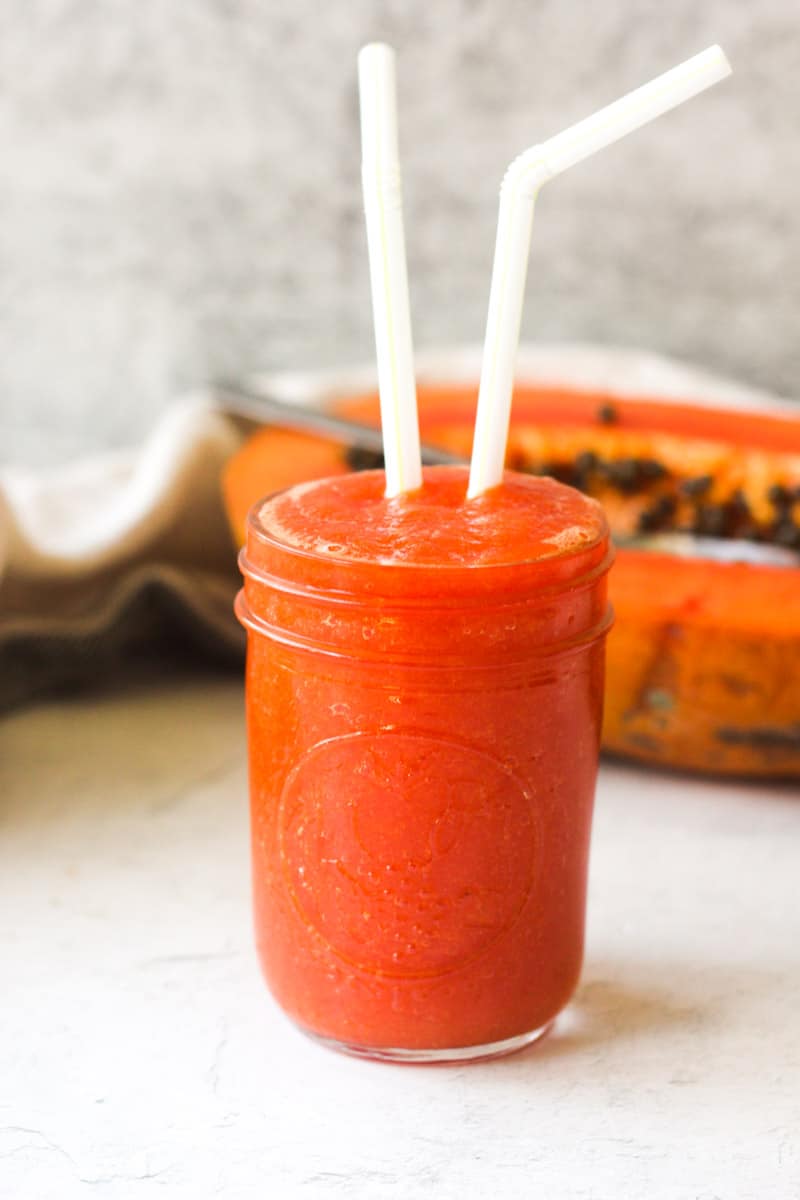 papaya juice recipe in a jar with straws
