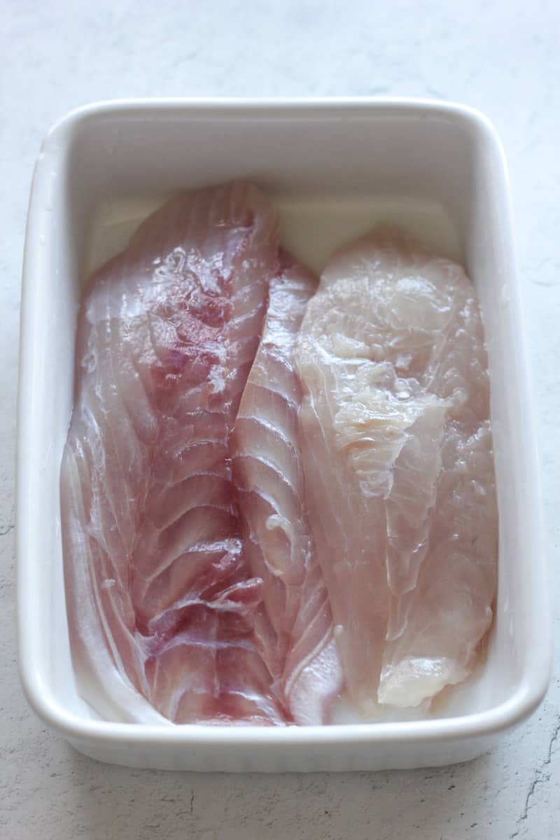 raw triggerfish in a baking dish