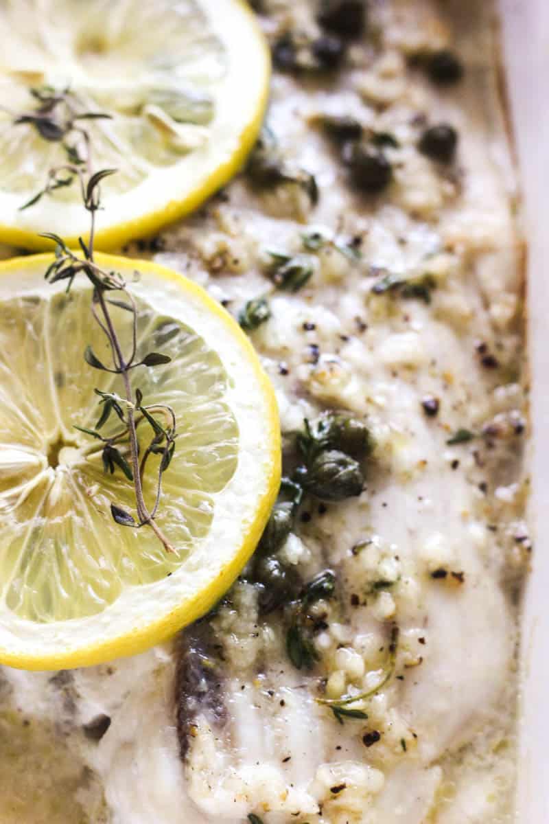 baked white fish with lemon slices and capers