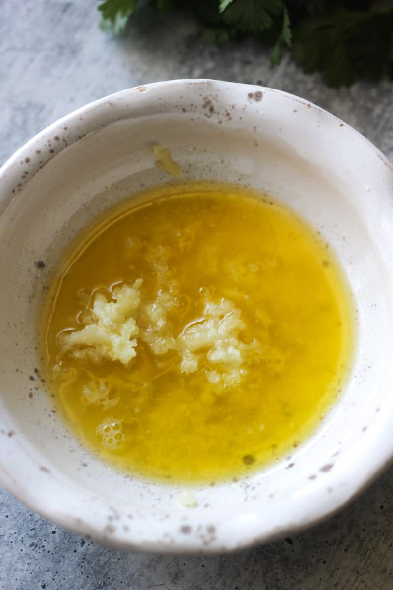 melted butter with chopped garlic in a small bowl
