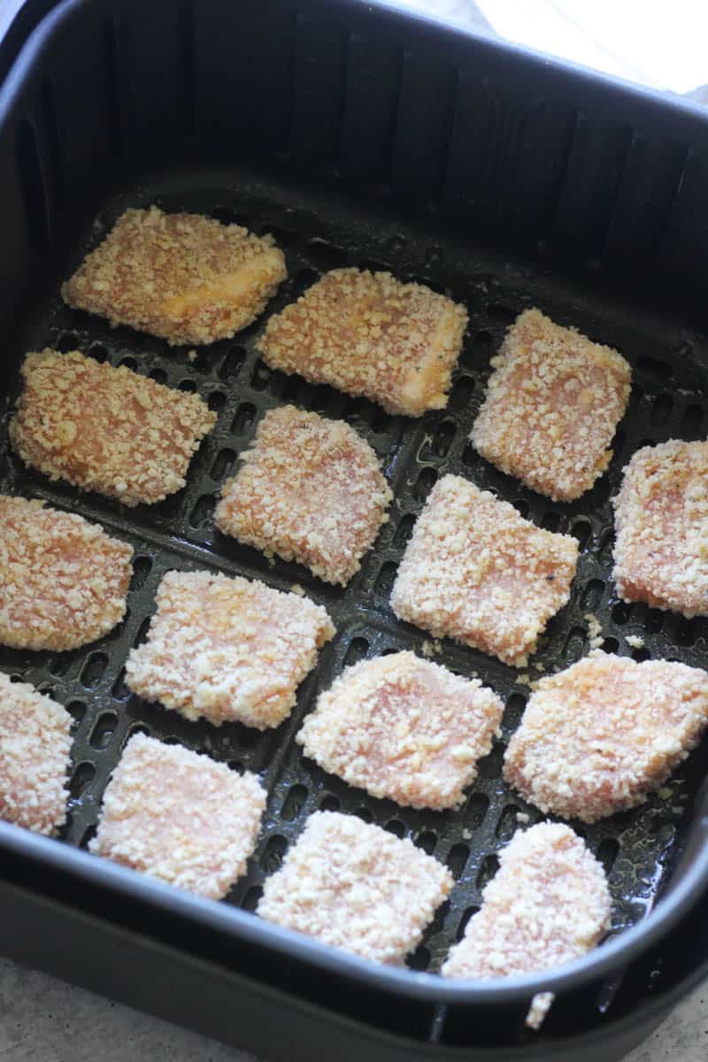 raw meat pieces covered in panko in air fryer