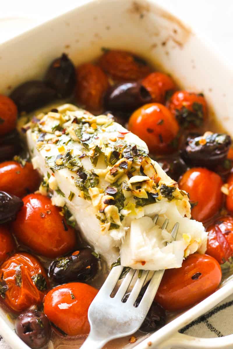 white fish fillet cooked with olives and tomatoes