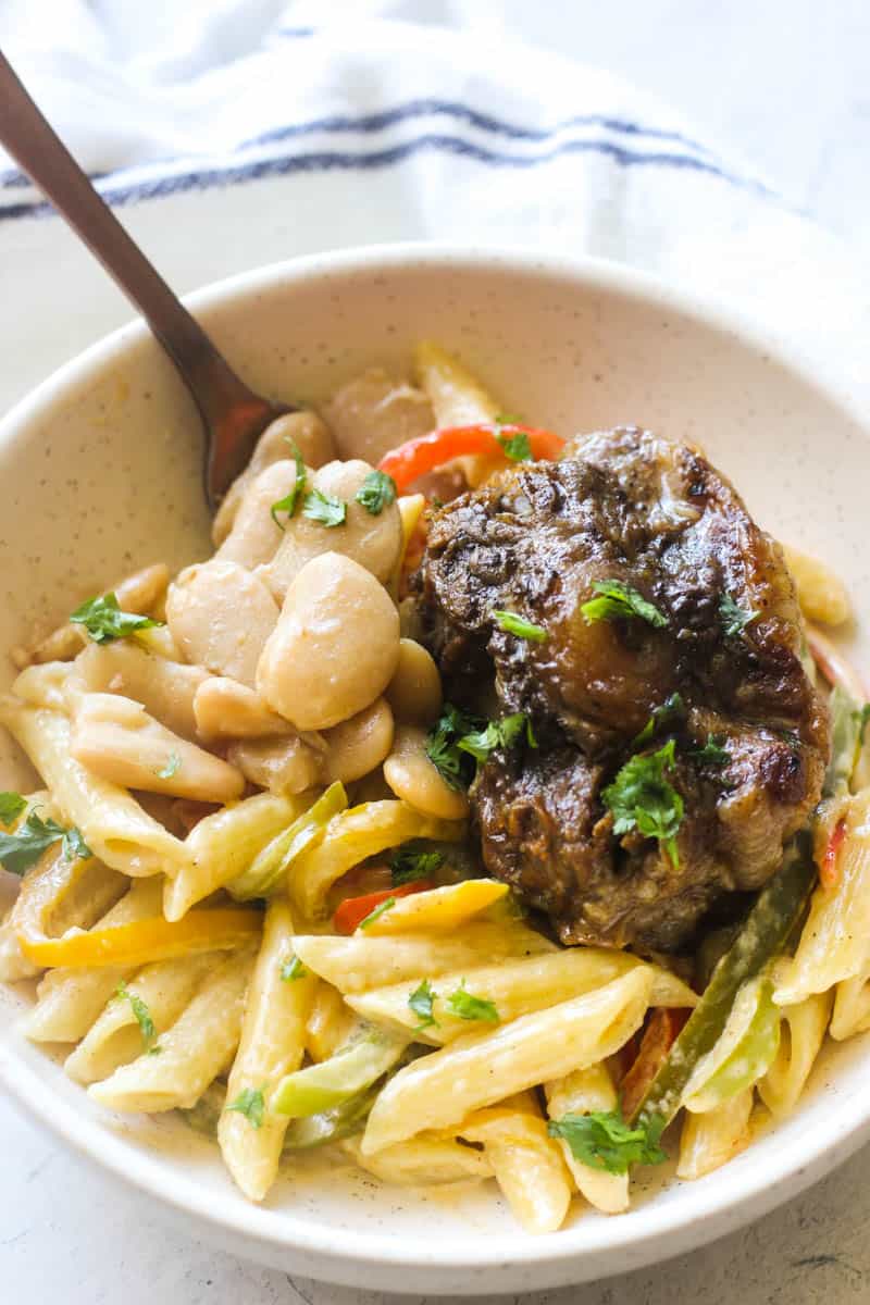 oxtail and butter beans on top of pasta