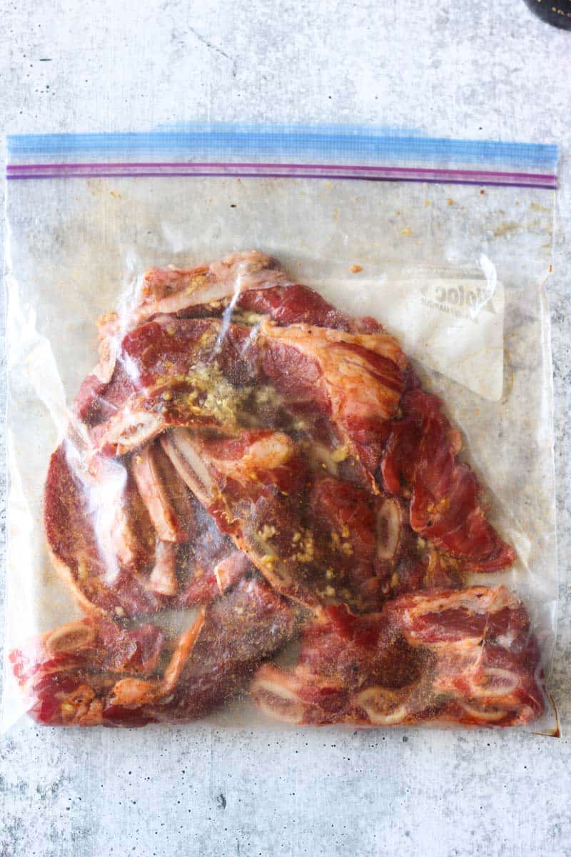 marinating beef short ribs in a large zip lock bag