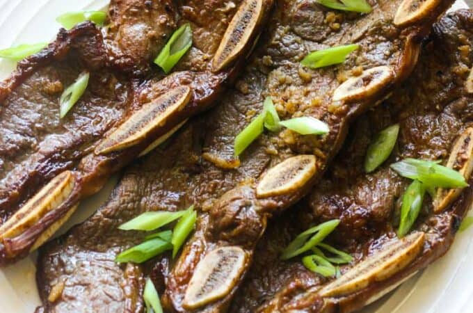 grilled beef short ribs with chopped green onions on top
