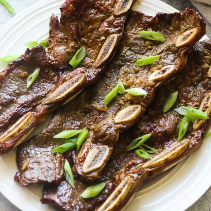 grilled beef short ribs with chopped green onions on top