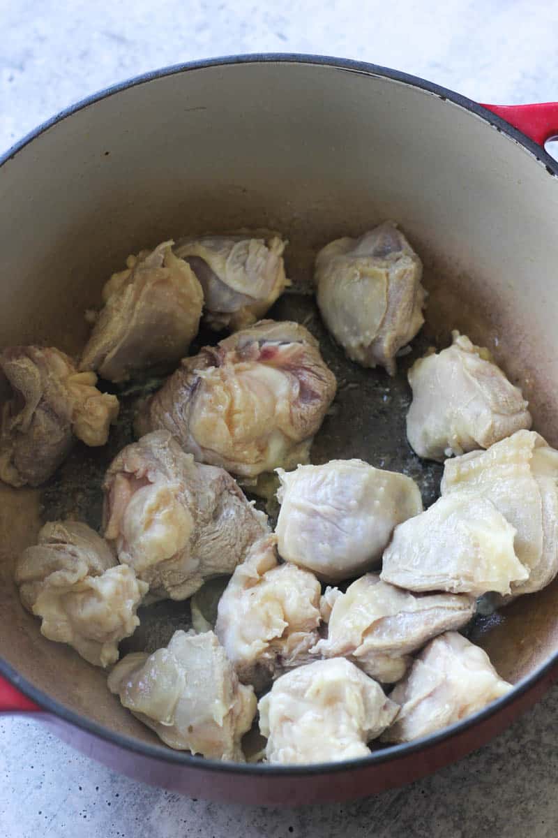 browning turkey knuckles in oil in red heavy pot
