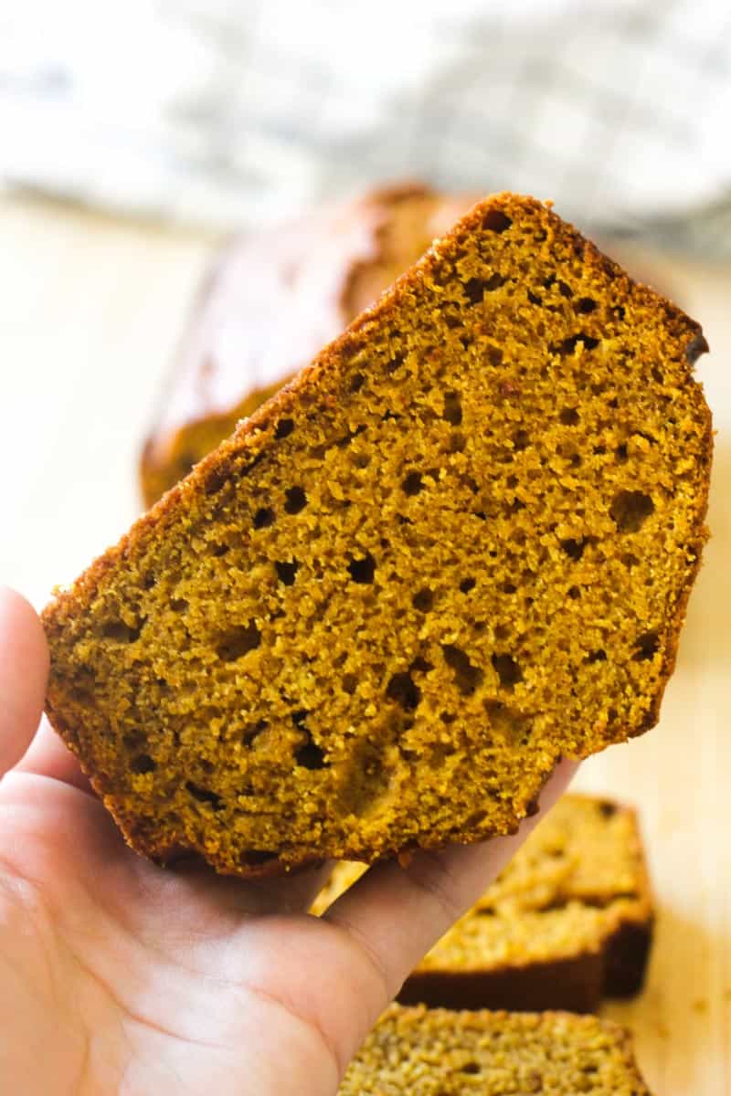 a piece of Amish pumpkin bread in hand
