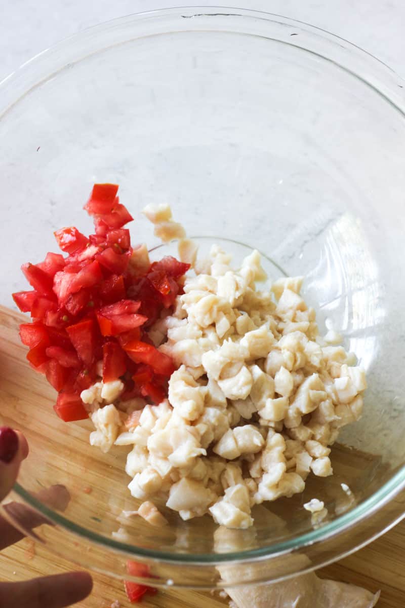 chopped conch and chopped tomatoes in the glass bowl
