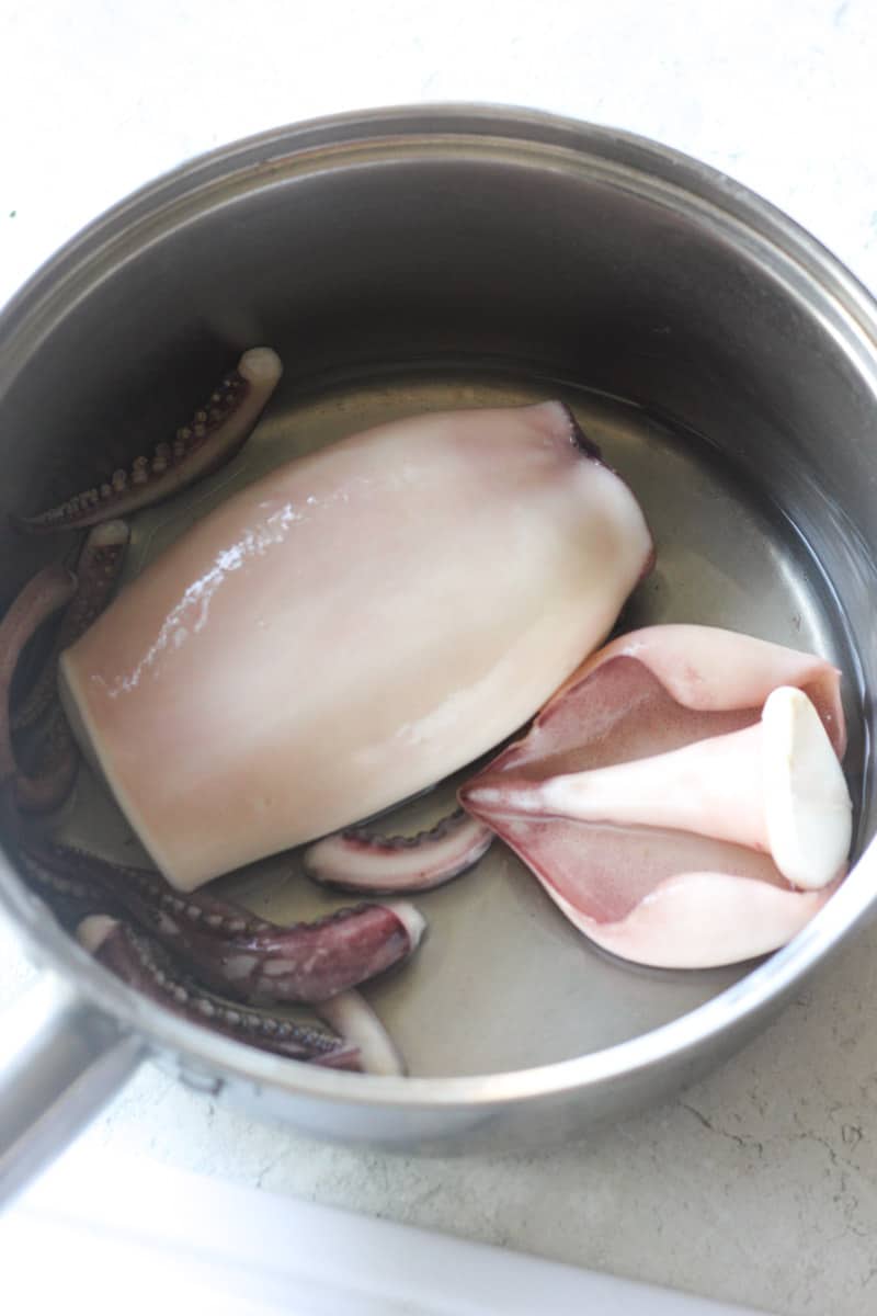 pieces of cooked squid in the stainless steel pot