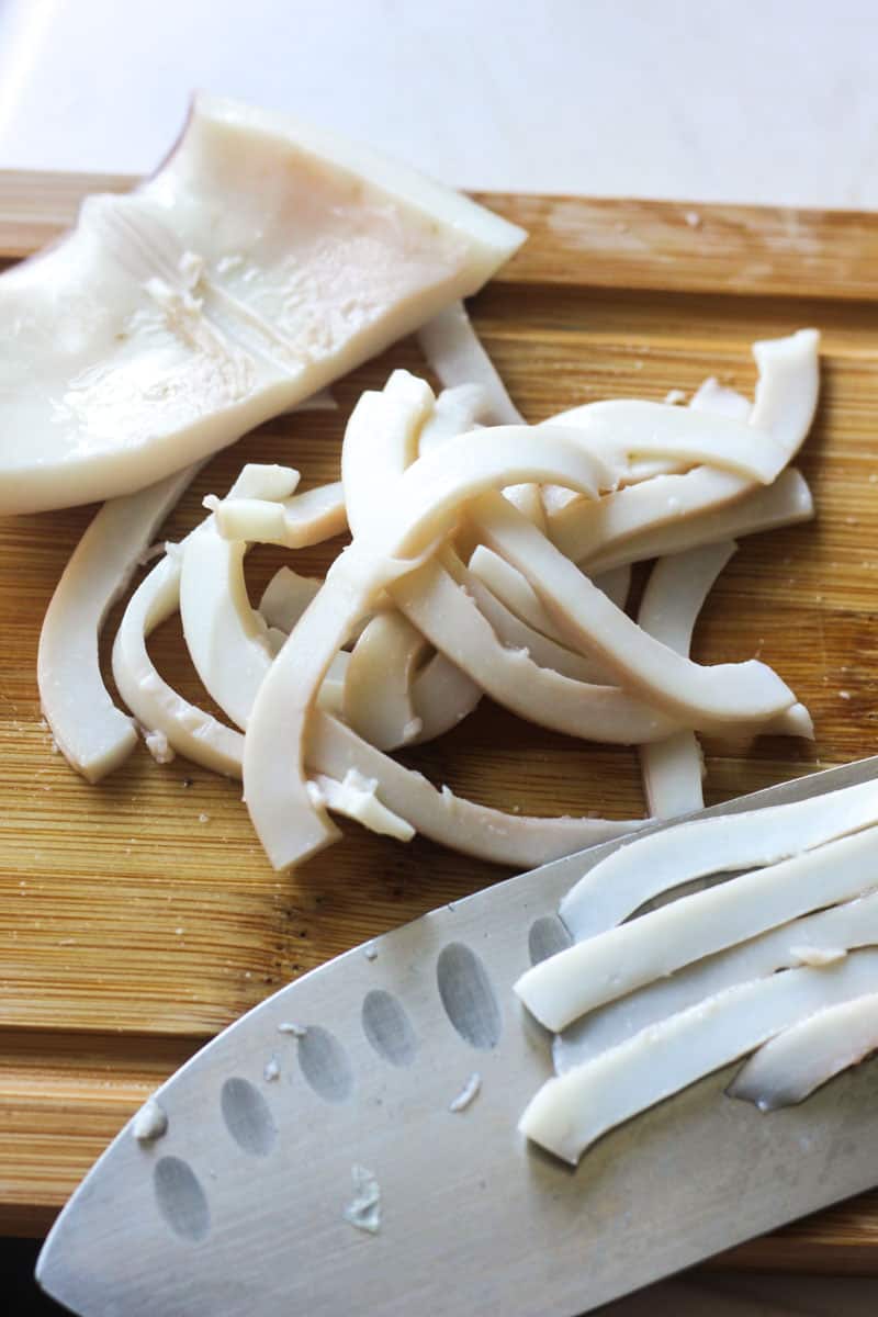 sliced cooked squid on the cutting board