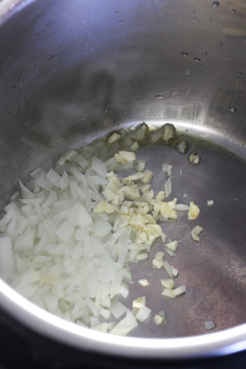 chopped onions and chopped garlic in the inner pot