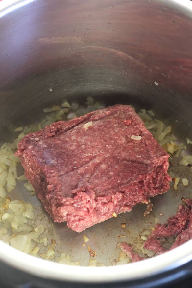 ground bison block with sauteed onions in the inner pot