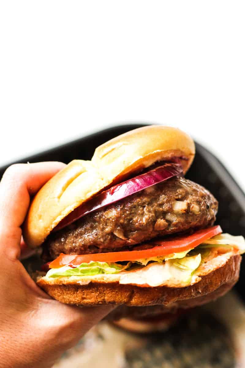 air fryer bison burger in hand