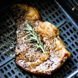 air fryer bison steak with rosemary on top