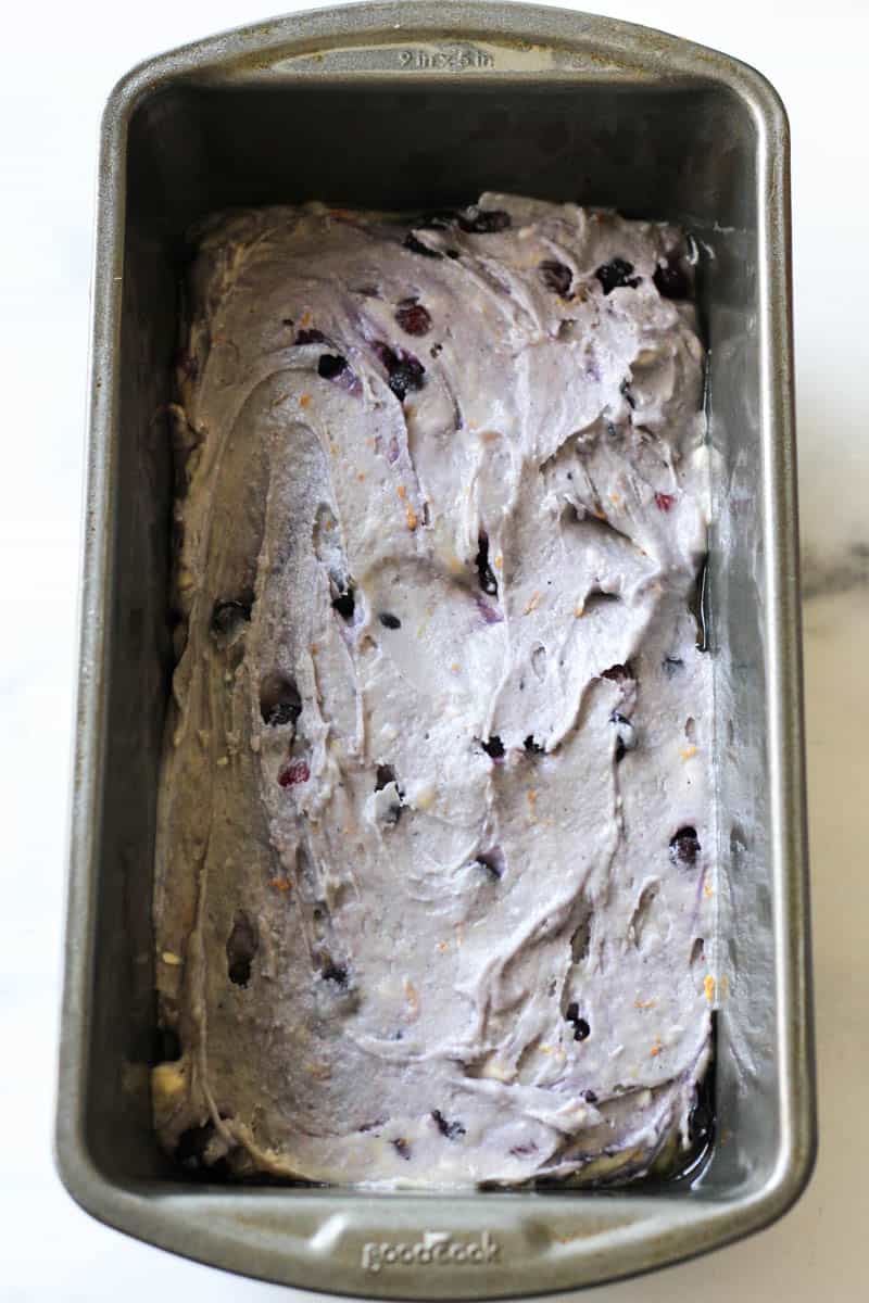 cranberry blueberry bread batter in the baking pan