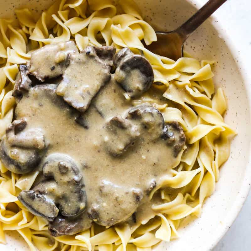 elk stroganoff with creamy sauce in a white bowl