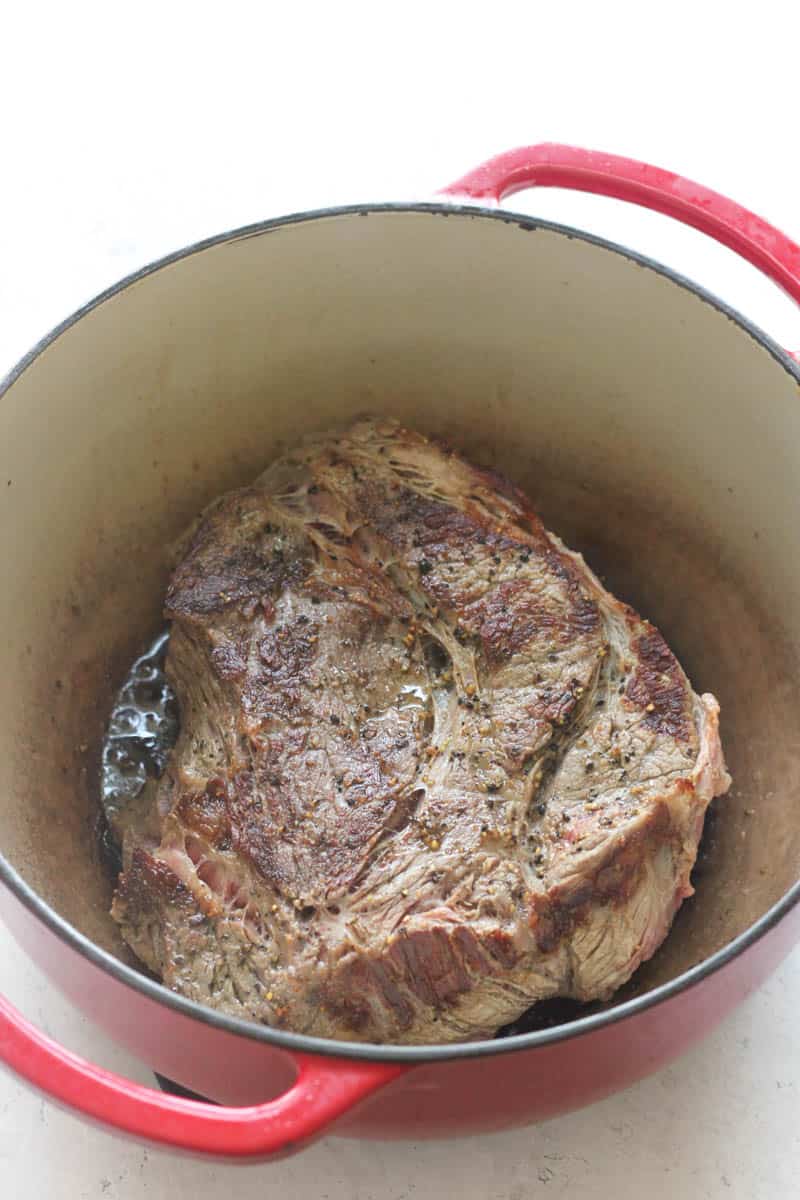 beef chuck roast in a red pot