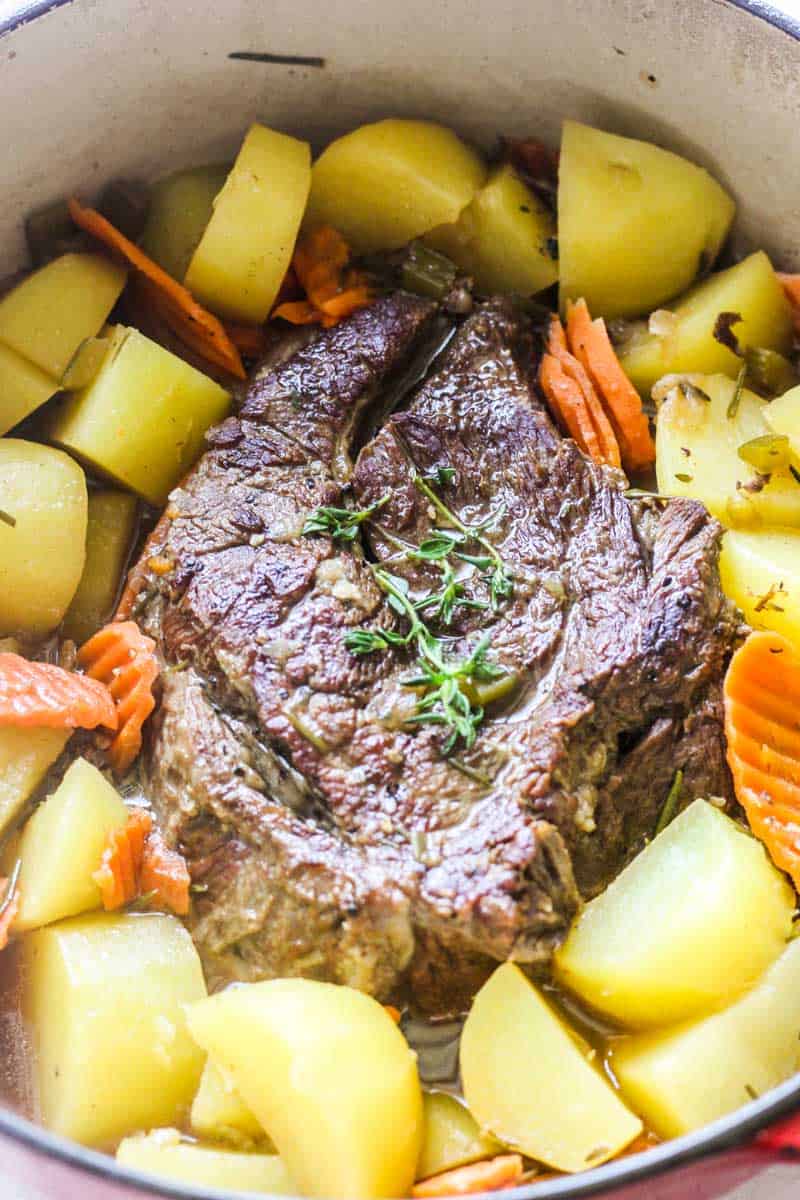 golden corral pot roast with thyme on top and potatoes and carrots around