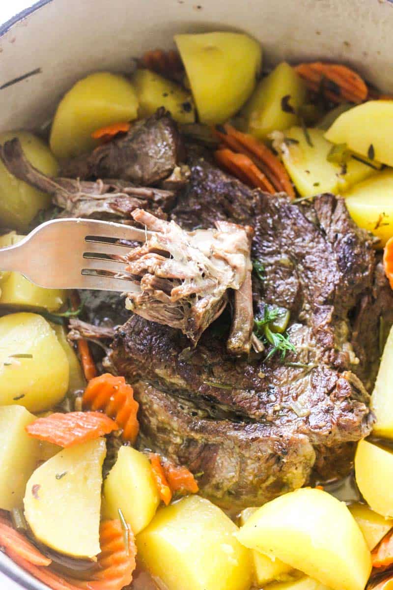 golden corral pot roast in a pot with fresh thyme on top