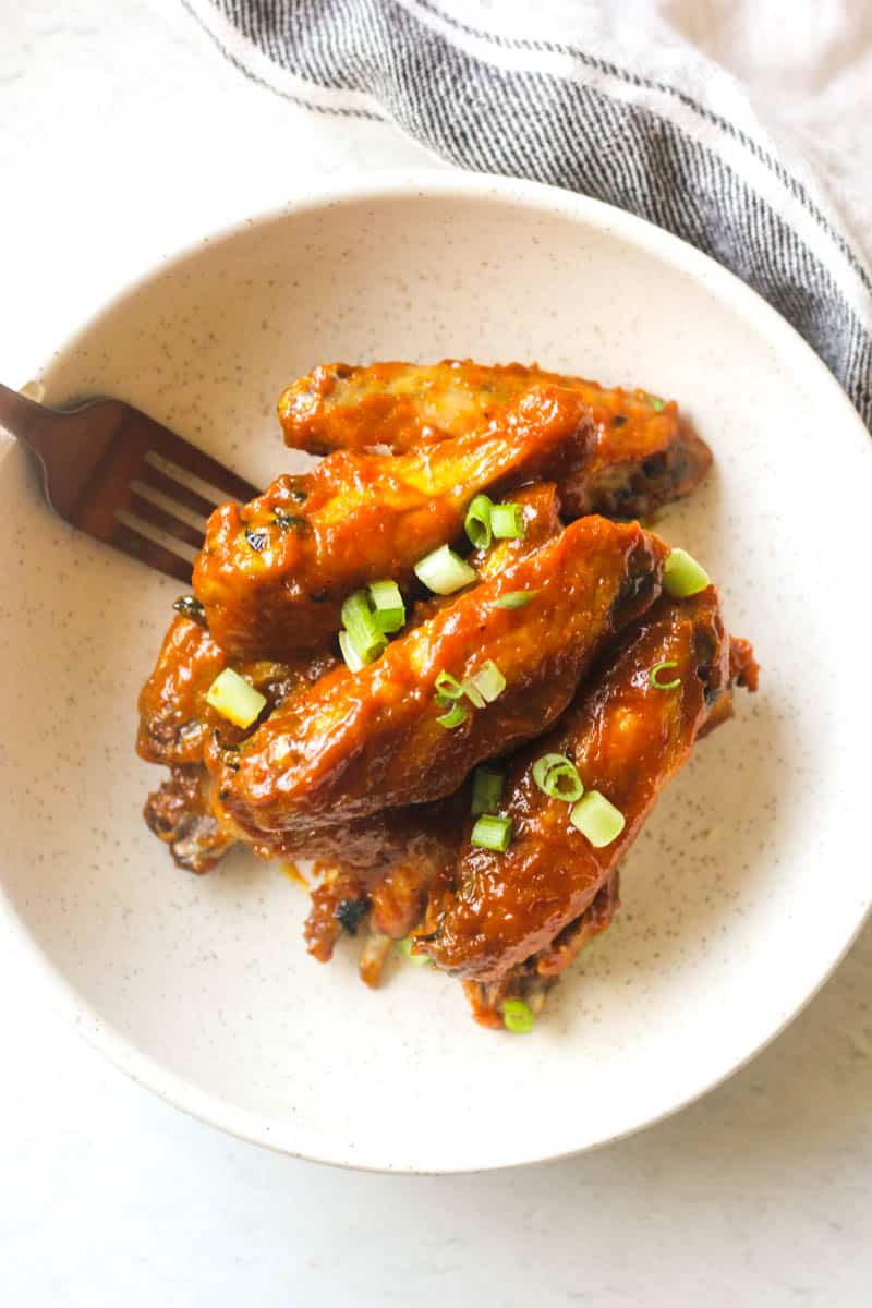 a few wings in honey gold sauce on a plate