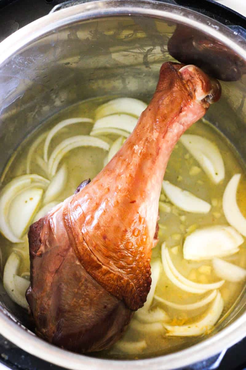 uncooked smoked turkey leg in inner pot