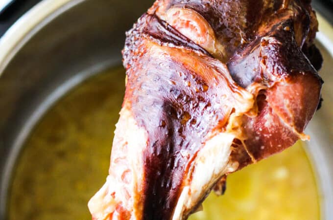 instant pot smoked turkey leg in hand