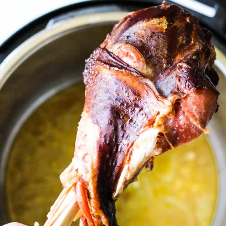 instant pot smoked turkey leg in hand