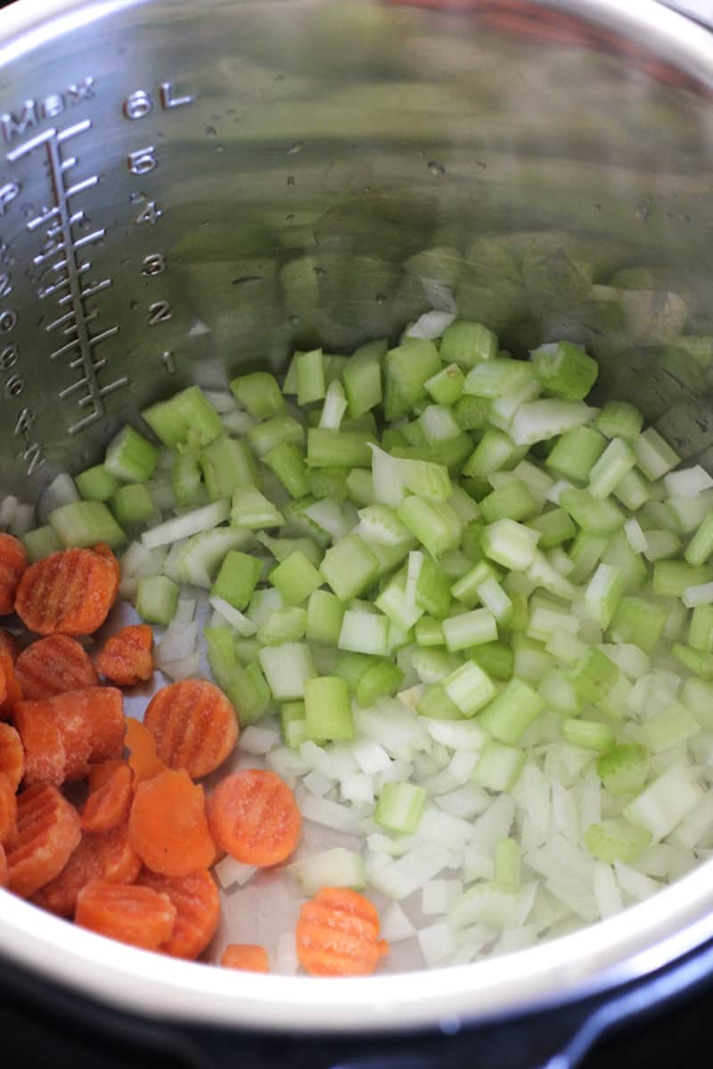 chopped celery and carrots in the pot