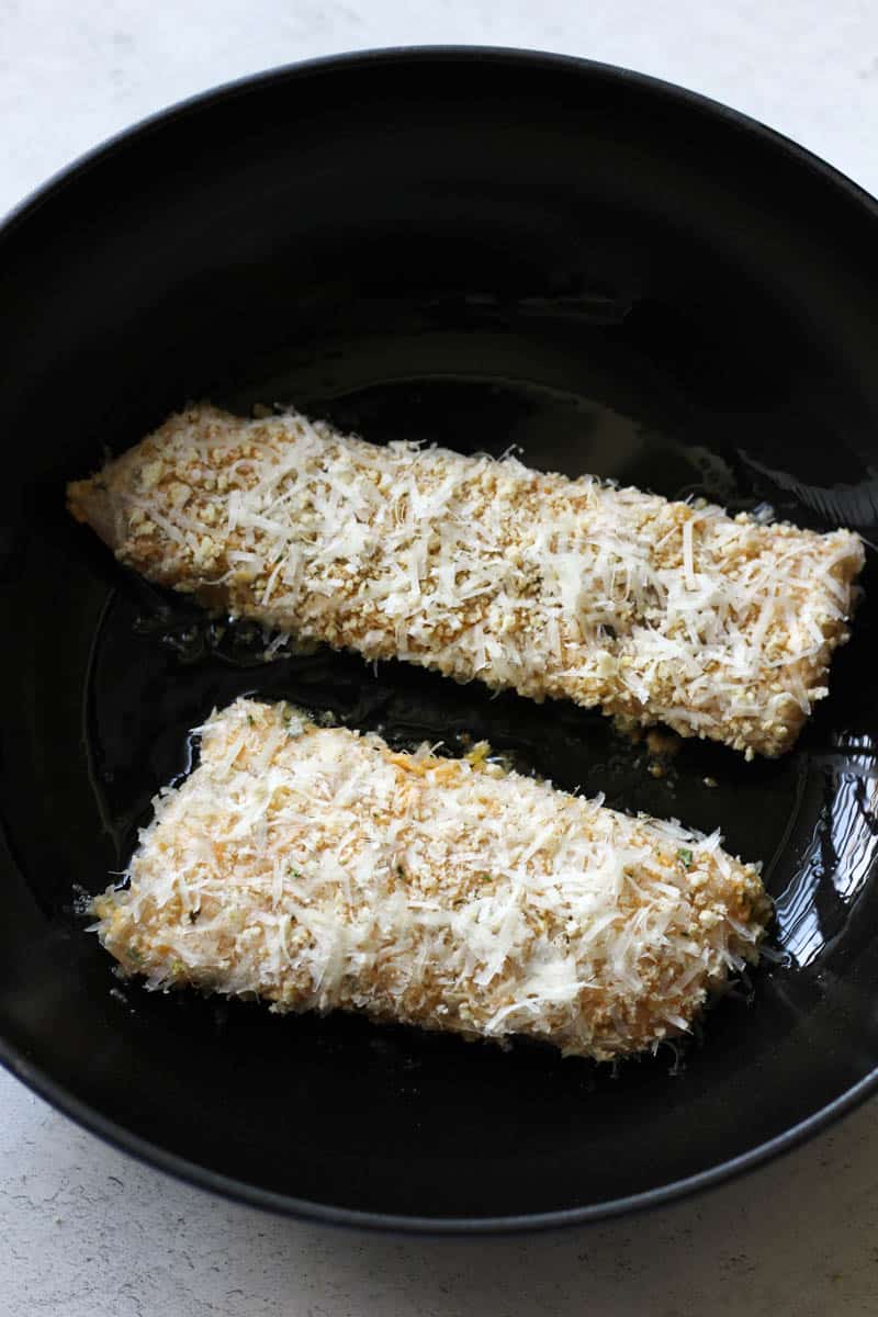 parmesan crusted walleye fillets in the pan