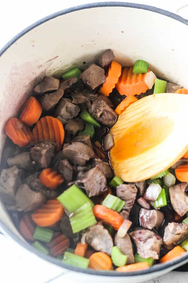 raw vegetables with raw meat in a pot before cooking