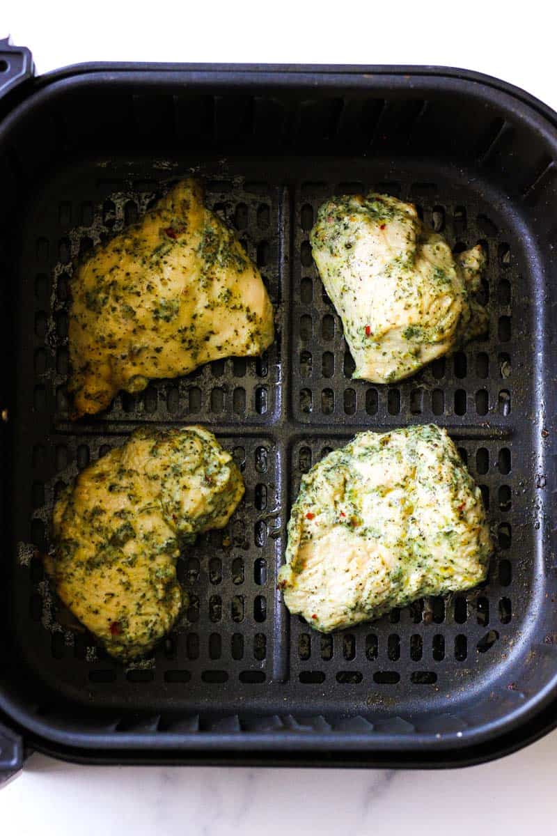 4 pieces of cooked pesto chicken breast in air fryer
