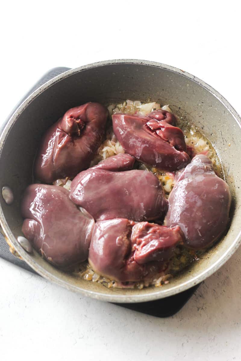 raw turkey livers in a pan before cooking