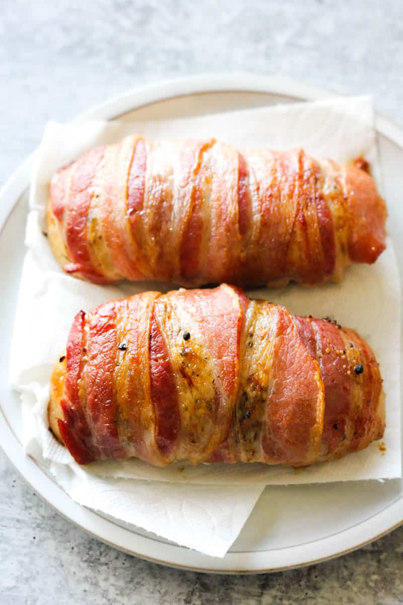 draining bacon wrapped duck on paper towels