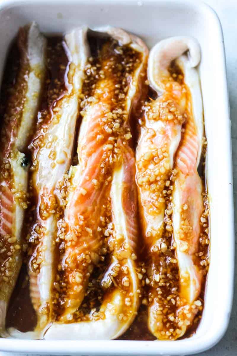 raw salmon bellies with marinade on top