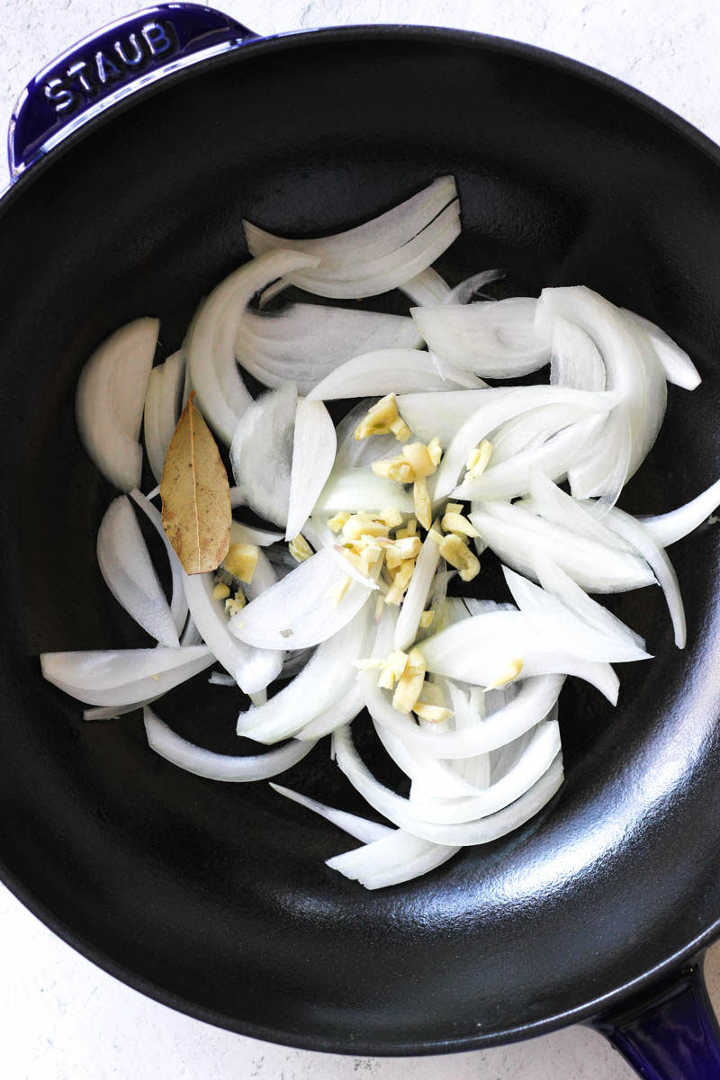 sliced onions with garlic in the pan