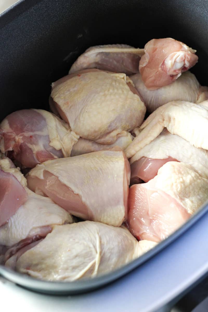 raw chicken pieces in the pot