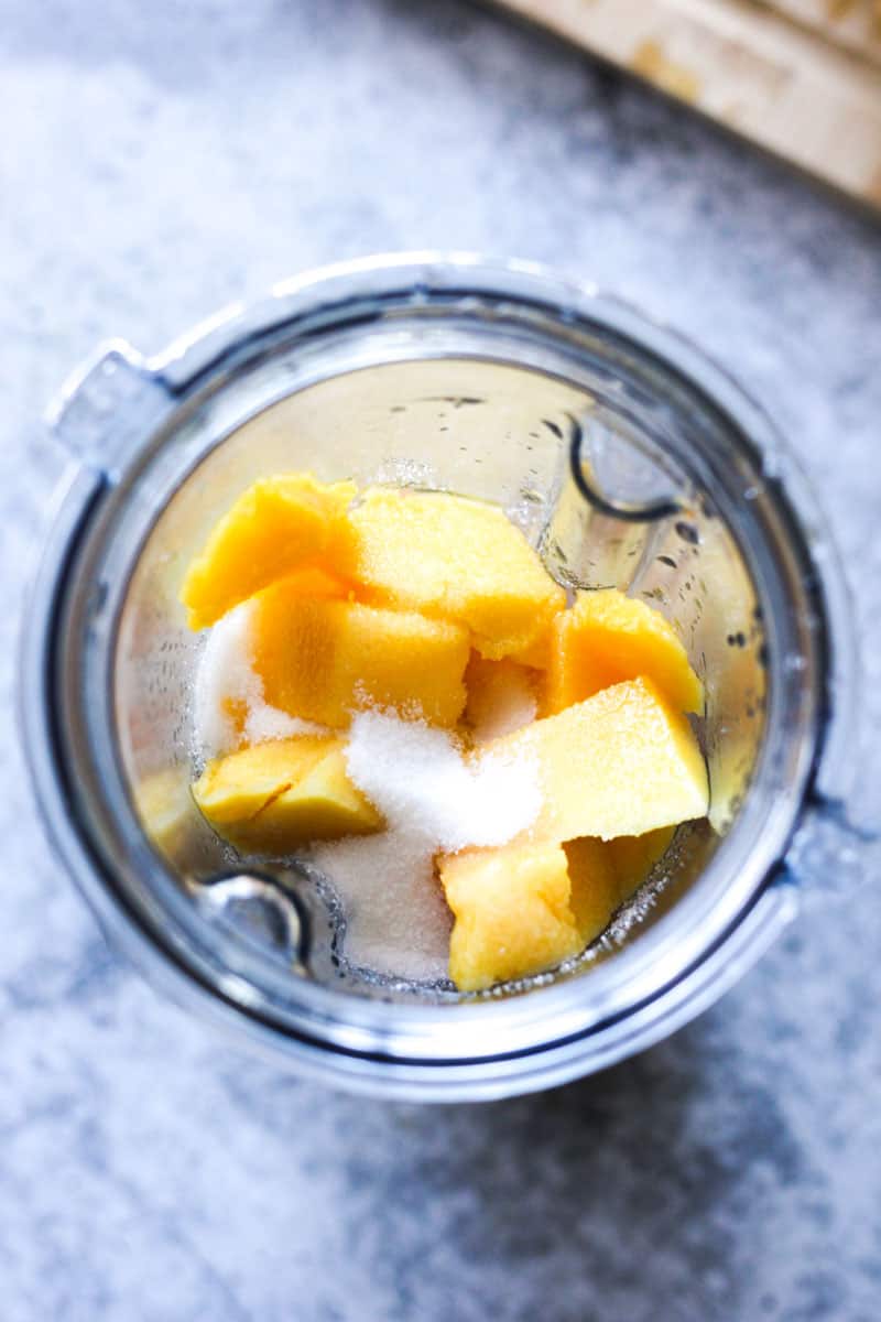 sugar on top of mango in the blender