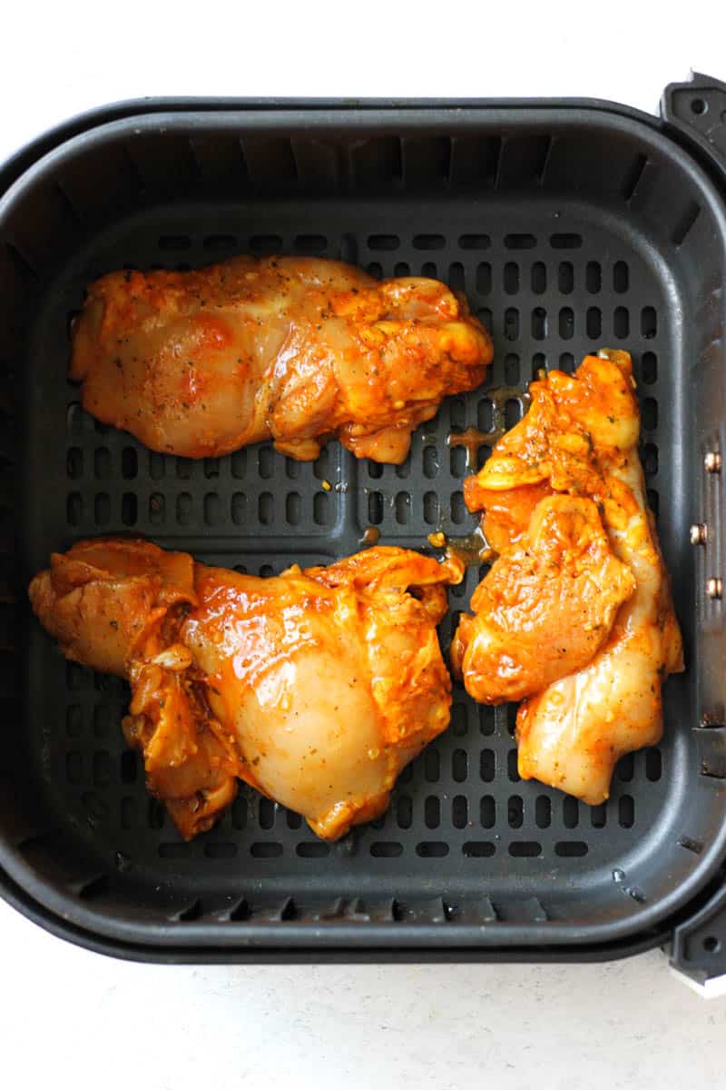 raw poultry in the black air fryer basket
