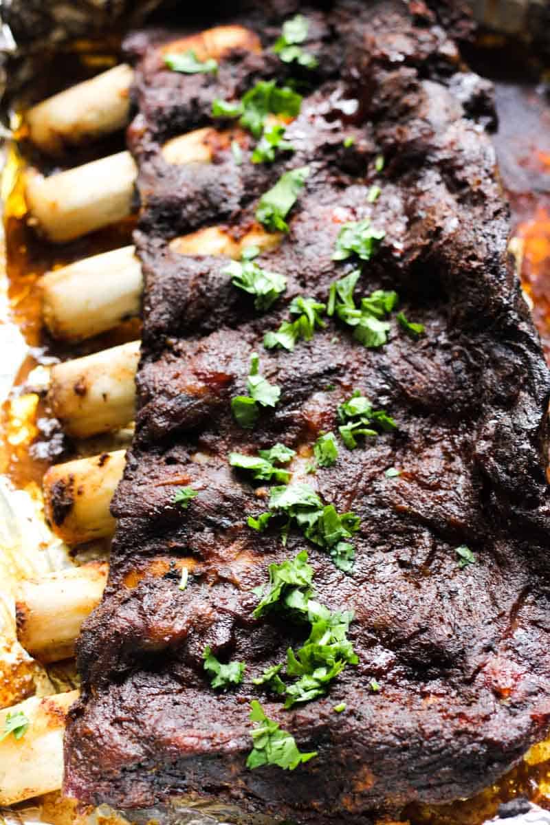 a rack of bison ribs cooked with bbq sauce and topped with chopped cilantro