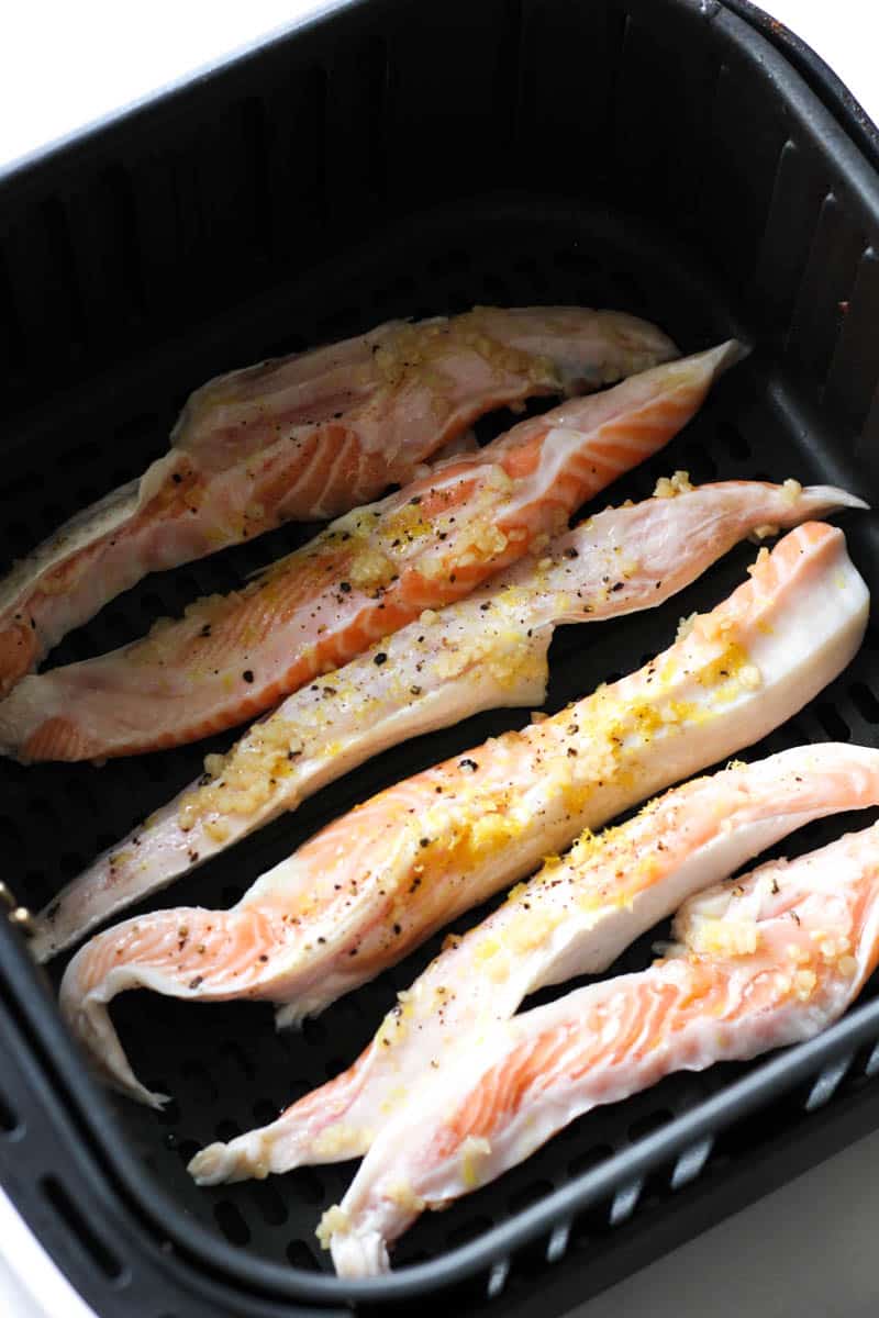 raw salmon belly in the air fryer basket