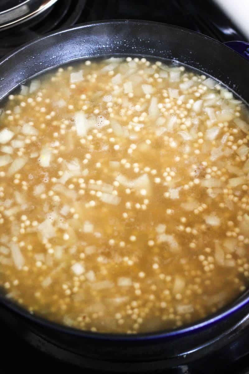 yellow broth with a blend of grains in the pan