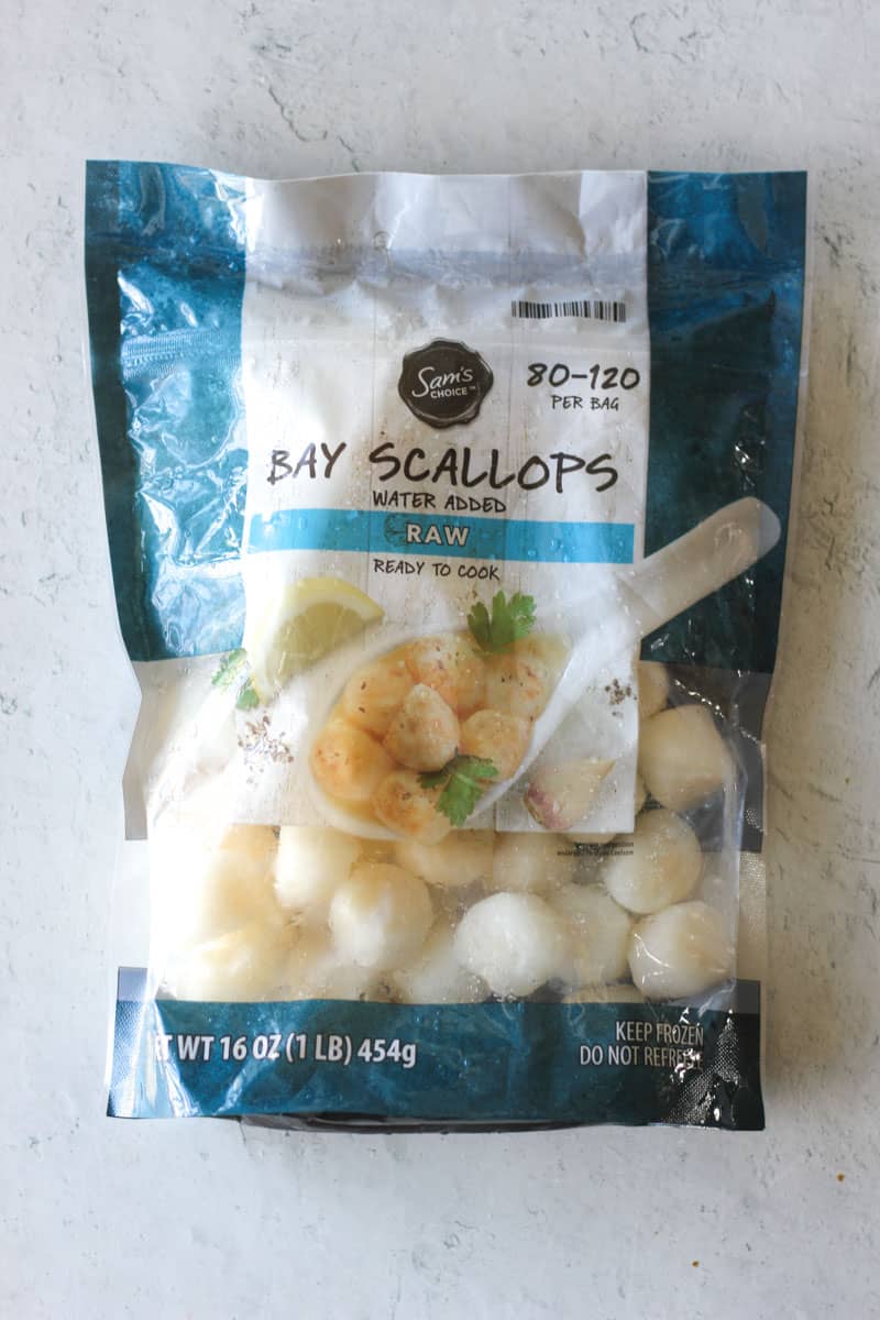 the plastic package of bay scallops on the table