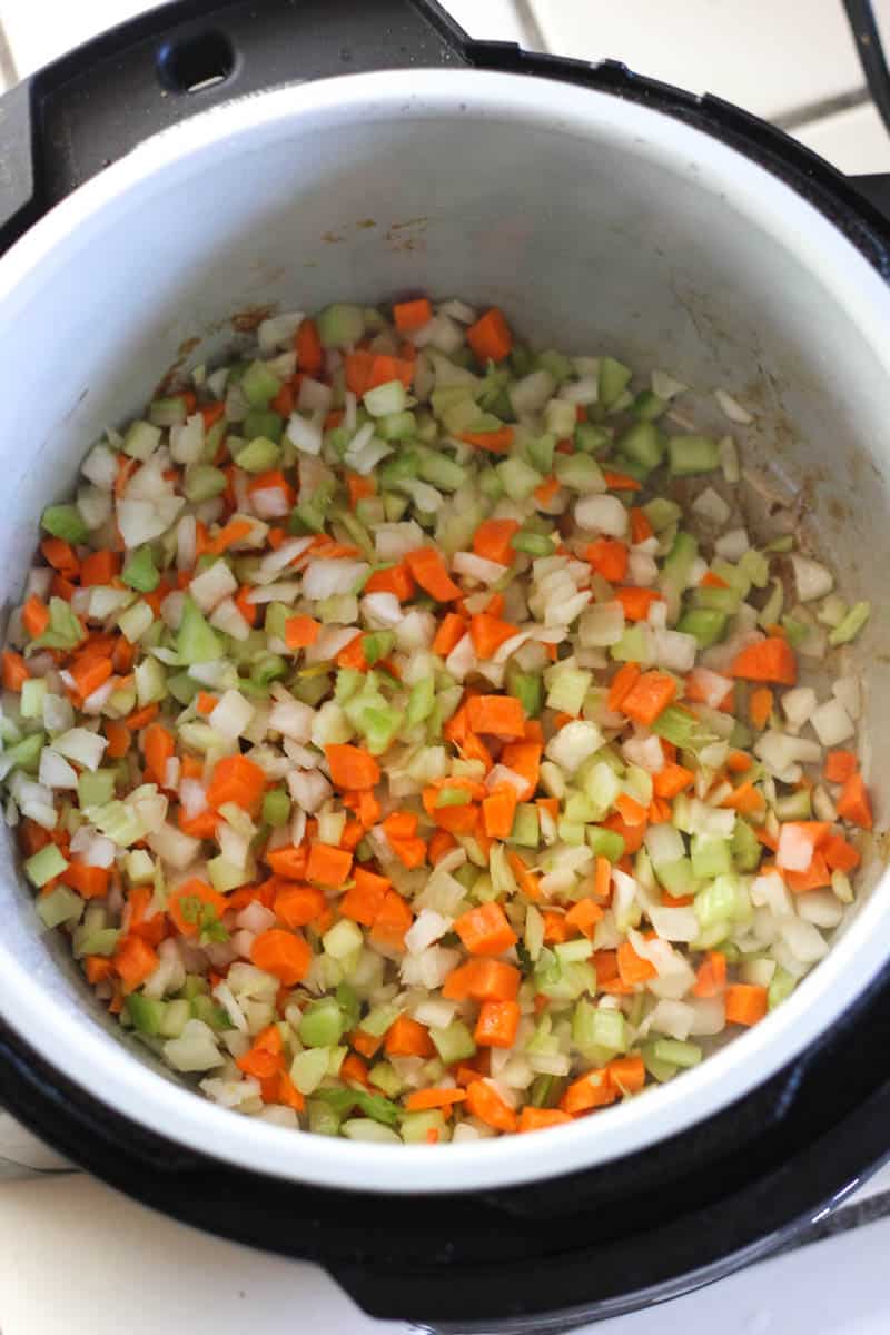 chopped carrots, celery and onions in the pot