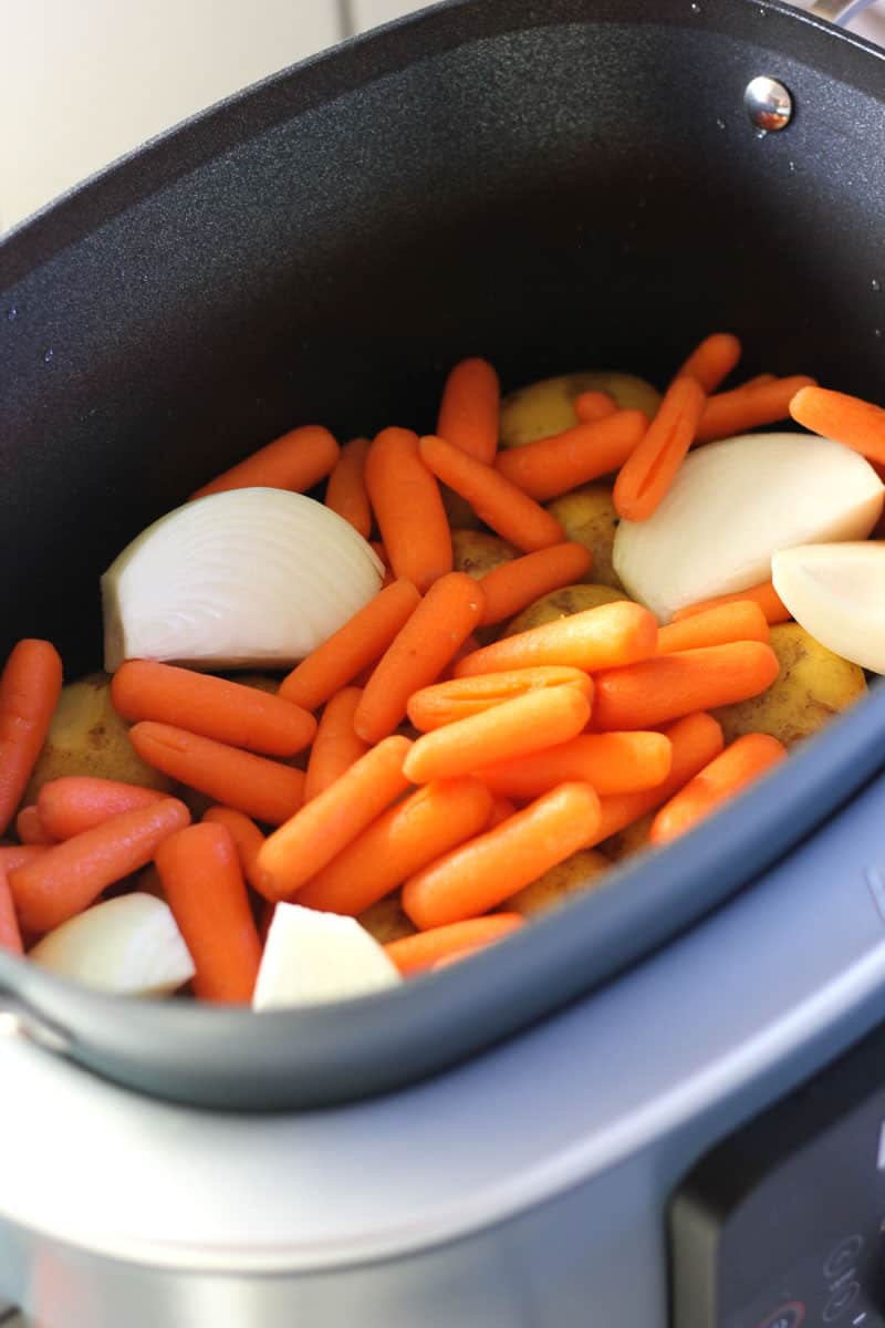 baby carrots and onions in the pot